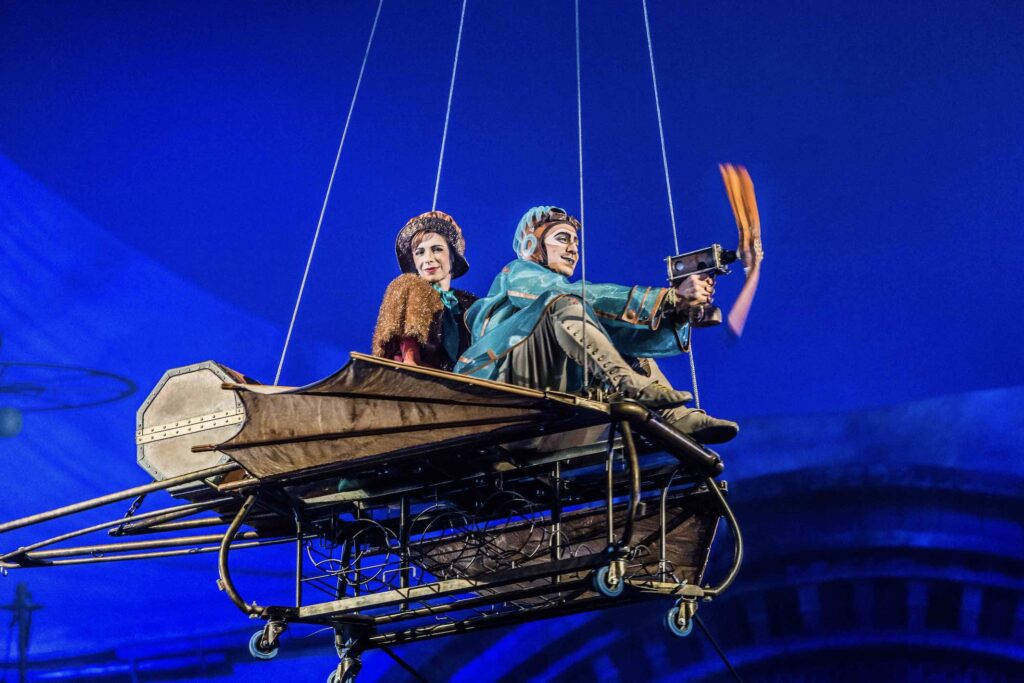 Cirque du Soleil’s KURIOS – Cabinet of Curiosities man and woman in flying machine