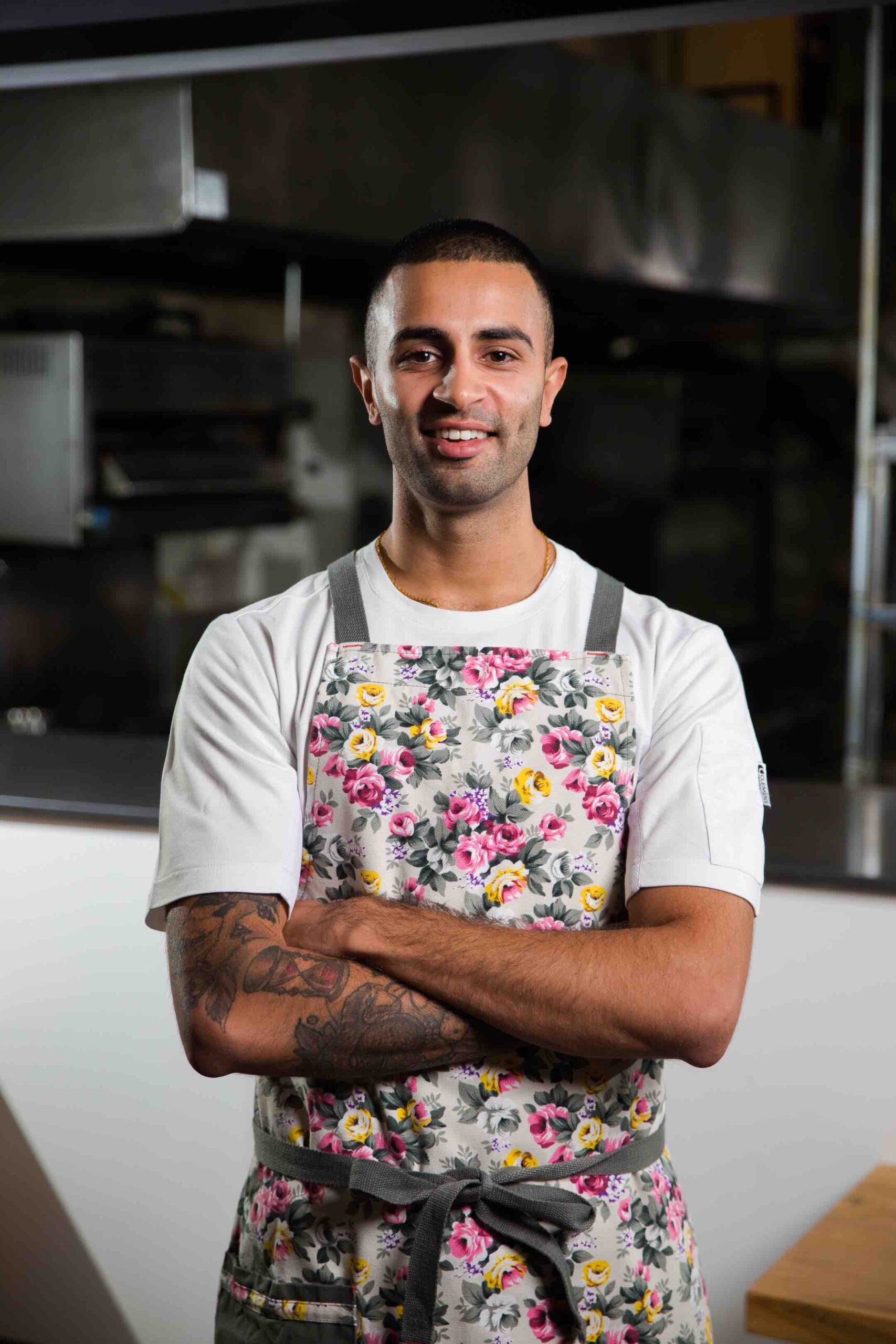 Chef Imrun Texeira with arms crossed in kitchen